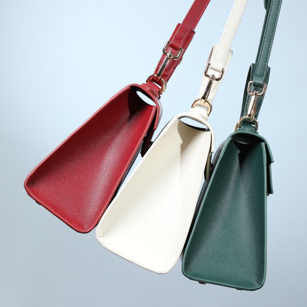 high-end designer purses in different colors, red bag, white bag and green bag